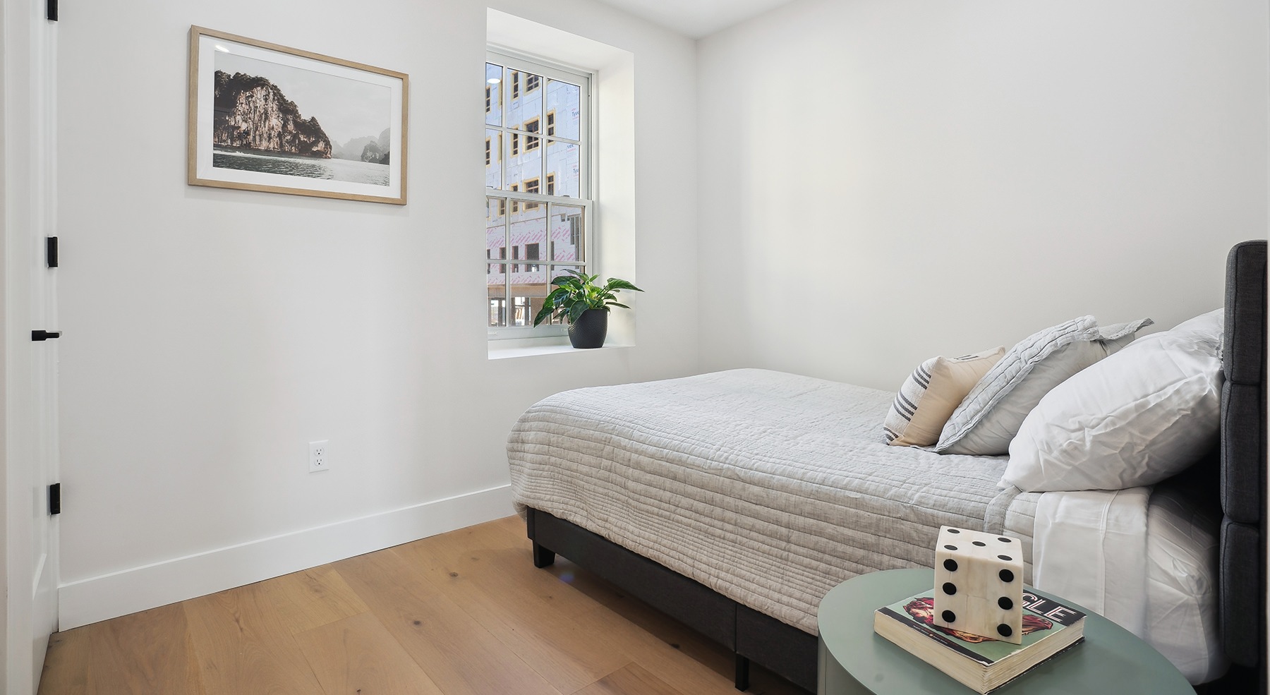 bedroom with a bed and a picture on the wall