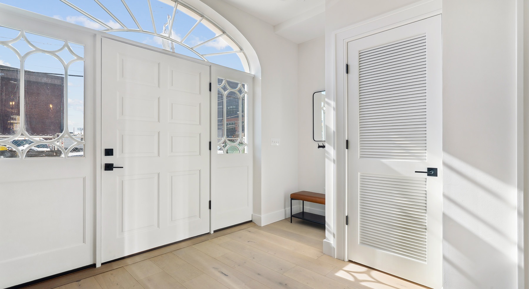 front door with window above it.