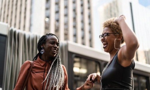 women laughing together in the city